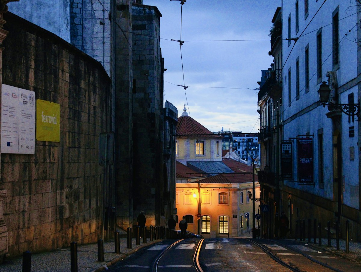 Narrow illuminated street in a European old town at dusk